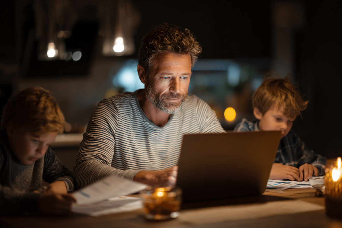 Father in his 40s reviewing MBDR retirement strategy with kids at kitchen table